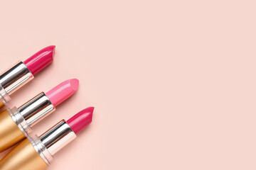 Different bright lipsticks on pink background