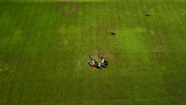 Aerial Shot Of People Discussing While Standing In Sports Field On Sunny Day - Boston, Massachusetts