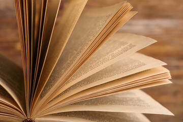 Closeup view of open old book on wooden background