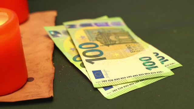 Hand puts money euro bills on a table with a green cloth, casually flapping his fingers, gesturing to offer a bribe for illegal payment Casino bet, tips, night shift pay Three hundred euro paper
