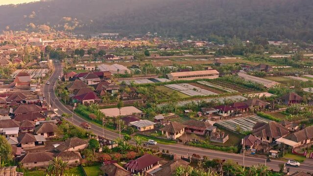 Silhouette travel people driving by scenic road Bali to major water temple Bali Pura Ulun Danu Bratan Bali, Indonesia 4K Aerial view