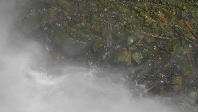 Bottom of Waterfall Mist Spray on Rocks Slow Motion