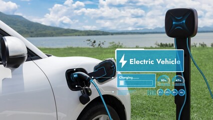 Electric car plug in with charging station, recharge battery by EV charger cable display smart digital battery status hologram with nature background. Futuristic green energy infrastructure.Peruse