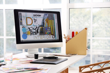 Interior designer's workplace with computer in office