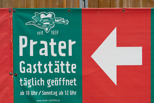 Werbung mit Richtungspfeil an einem Zaun für den ältesten Biergarten in Berlin, den Prater im Stadtteil Prenzlauer Berg