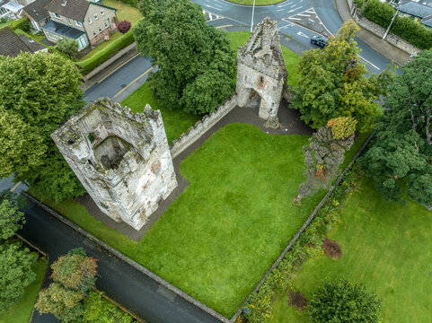 Aerial view of Monkstown castle near Dublin Ireland with restored gate tower and keep dramatic sunset sky