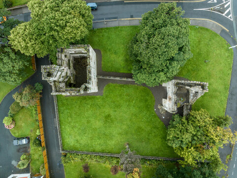 Aerial view of Monkstown castle near Dublin Ireland with restored gate tower and keep dramatic sunset sky