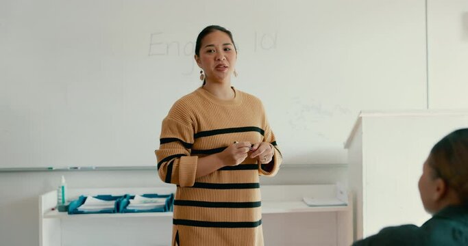 Education, english and presentation with a woman teacher in class for learning, growth or development. School, whiteboard and teaching with a young educator talking to students in a college classroom