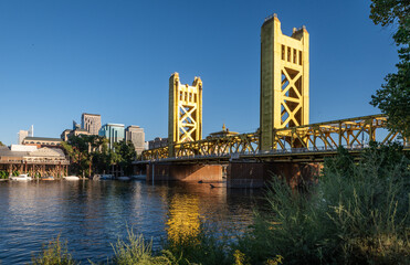 Photo of the golden Tower Bridge over the Sacramento River. The bridge is the western downtown entry point to the city of Sacramento, capital of California.