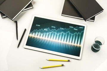 Modern digital tablet monitor with abstract creative financial chart, research and strategy concept. Top view. 3D Rendering