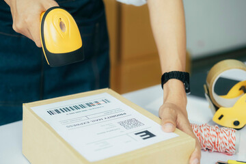 Scanning parcel barcode before shipment.. - obrazy, fototapety, plakaty