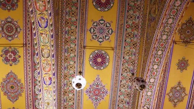 artistic design of temple roof with lighted Chandelier from low angle video is taken at Soni Ji Ki Nasiya Jain Temple, Ajmer, Rajasthan, India on Aug 19 2023.