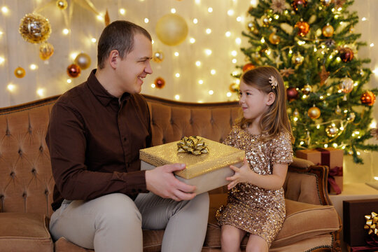 Father giving gift to his little daughter