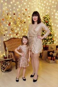 Mother and daughter posing in christmas decorated room