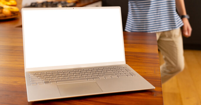 Laptop with copy space lying on table top in kitchen