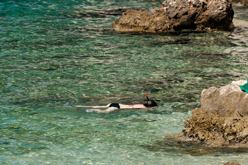 Snorkelist in crystal clear water of Adriatic sea in Brela on Makarska Riviera, Dalmatia, Croatia