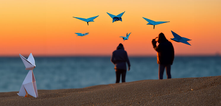 pajaros de origami volando sobre la playa al atardecer, Silueta 