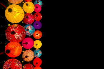 Colorful Chinese lanterns on black background with copy space