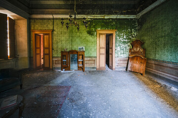 Fototapeta na wymiar dismantled bed and dresser in an abandoned house
