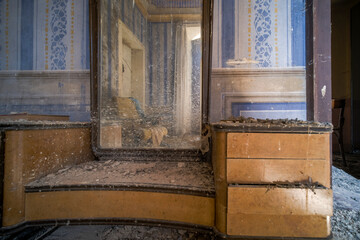 reflection of an armchair in the mirror in an abandoned house