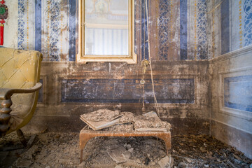 dusty books and mirror in an abandoned house