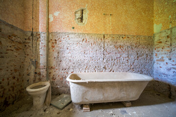 broken bathtub in an abandoned house