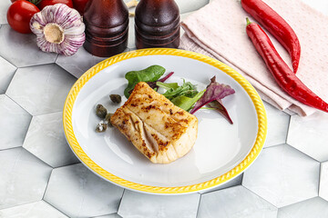Roasted cod fish steak with salad