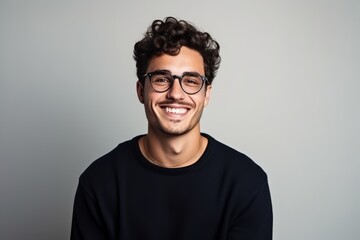 Portrait of a handsome young man wearing glasses and looking at camera.