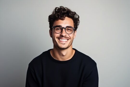Portrait of a handsome young man wearing glasses and looking at camera.