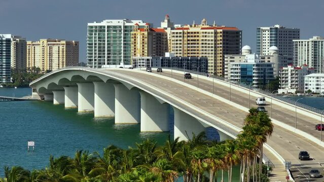 USA travel destination. Aerial view of Sarasota city downtown with Ringling Bridge and high-rise office buildings on horizon. Real estate development in Florida