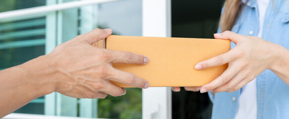  woman receives boxes parcel from courier in front house. Delivery man send deliver express. online shopping, paper containers, takeaway, postman, delivery service, packages - obrazy, fototapety, plakaty