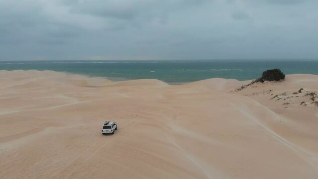 White 4x4 car driving on dunes at Western Australia, aerial