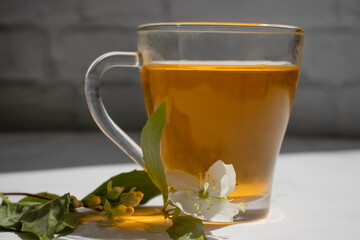 Cup of tea with fresh jasmine flower