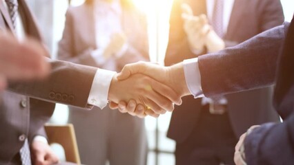 businessman and businesswoman shaking hands in hallway.