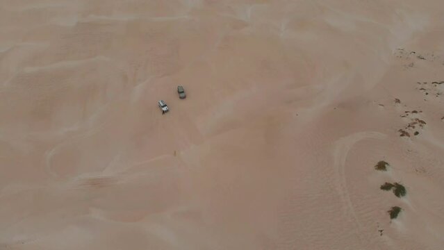 Top down of cars parked on sand dunes western Australia, aerial