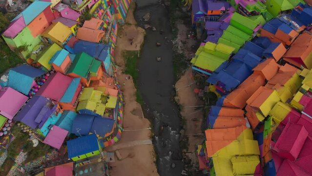 Flying over Jodipan Kampung Biru Arema rainbow village, aerial