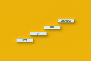 The words step by step strategy on blocks. Business concept. Persistent movement towards the goal. Moving forward. Professional growth. Successful tactics. 3d render