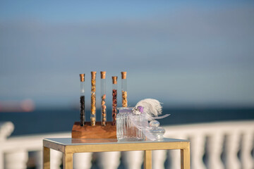 Flasks and jars. Table on the seashore