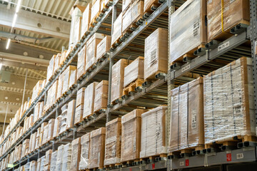  Long shelves with many cardboard boxes with product in warehouse of IKEA 