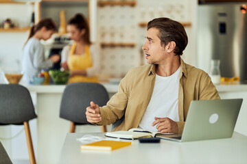A man who works at home trying to silence his wife and daughter.