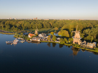 Aerial drone view of De Ster and De Lelie at Kralingse Plas in Rotterdam-Kralingen, showcasing the only remaining working snuff and spice mills in the Netherlands. © Sepia100