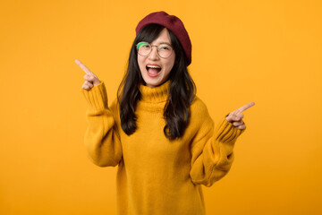 young Asian woman in her 30s, wearing a yellow shirt and red beret. happy face and pointing finger...