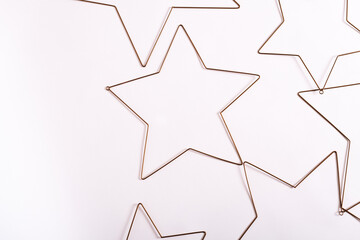 Thin metal star decorations neatly placed on a white background, creating a minimalist look.