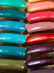 A high angle shot with swatches and manicures of different shades and colors