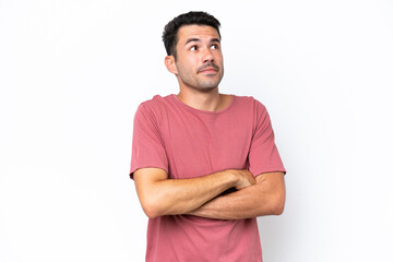 Young handsome man over isolated white background making doubts gesture while lifting the shoulders