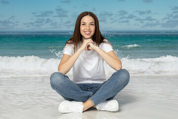 Fototapeta na wymiar Attractive young woman sitting on the beach, vacation