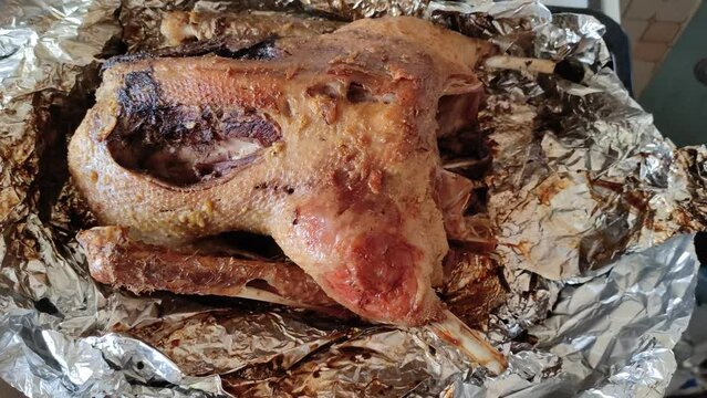 Roast in foil goose on a plate