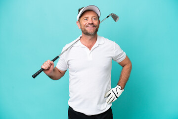 Middle age caucasian golfer player man isolated on blue background posing with arms at hip and...