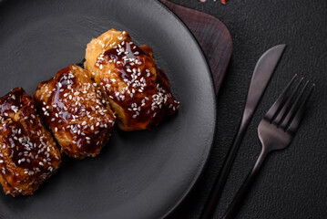 Delicious juicy fried chicken with sweet and sour teriyaki sauce and sesame seeds