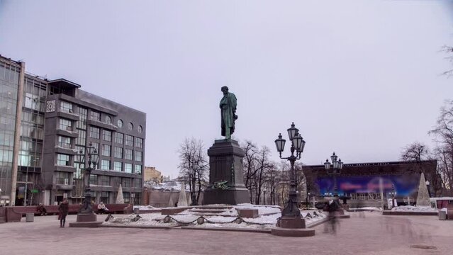 Winter Timelapse Hyperlapse of Monument to Russian Poet Alexander Pushkin on Pushkin Square with Snow-Covered Ground and Illuminated Surroundings, Moscow, Russia